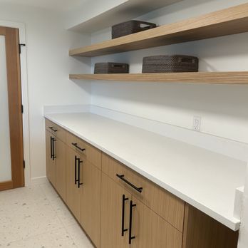 Third Arm Construction - Folding space in the laundry area with custom shelving units and cabinetry. - General Contractors Near Me - Lynnwood, Washington