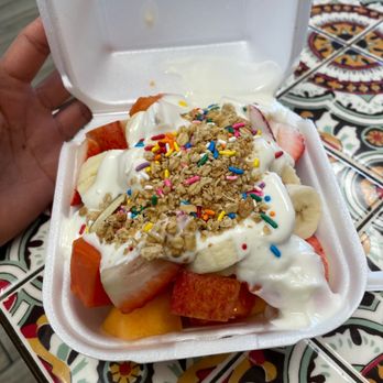 Jugos Vallarta - a hand holding a container of fruit and yogurt - Mexican Near Me - Santa Ana, California