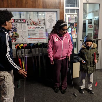 Lessard Lanes - Picking out mini golf sticks - Bowling Near Me - Plainville, Connecticut