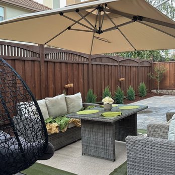 New Era Design - a patio with a hanging chair - Landscape Architects or Designers Near Me