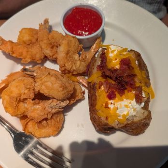 Cheddar's Scratch Kitchen - Shrimp with cocktail sauce accompanied by a fully dressed baked potato - Comfort Food Near Me - Sanford, Florida Cheddar's Scratch Kitchen - Shrimp with cocktail sauce accompanied by a fully dressed baked potato - Comfort Food Near Me - Sanford, Florida