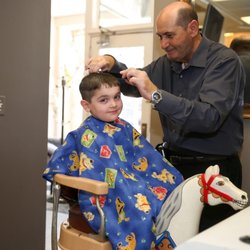 Hair Cottage - Patsy cutting his amazing client on the very well known 'horsey chair'