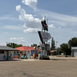 Motel Safari - A view of the sign and outdoor lounge.