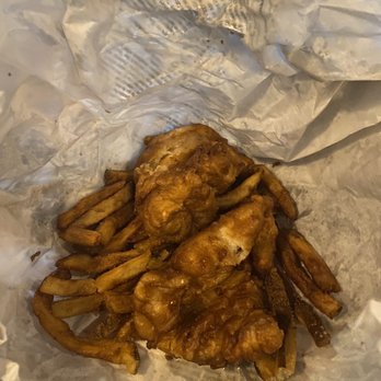 Fiddler's Hearth - Fish and chips unwrapped from its original newspaper wrapping - Irish Near Me - South Bend, Indiana