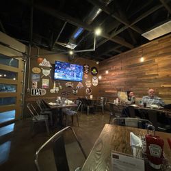 Squeeze Burger & Brew - Interior of restaurant at end where the big roll up door that is opened for nice weather
