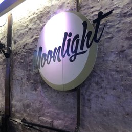 a neon sign on a brick wall a neon sign on a brick wall