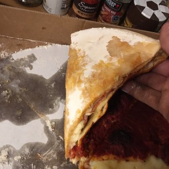 Rick's Una Pizza - a hand holding a piece of pizza - Pizza Near Me - Henderson, Kentucky Rick's Una Pizza - a hand holding a piece of pizza - Pizza Near Me - Henderson, Kentucky