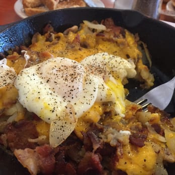 Garden Grille Cafe - Supreme Skillet- Sausage, bacon, potatoes, onions, mushrooms and cheddar cheese (comes with American) poached eggs. HUGE portion. - Breakfast & Brunch Near Me - Palm Harbor, Florida Garden Grille Cafe - Supreme Skillet- Sausage, bacon, potatoes, onions, mushrooms and cheddar cheese (comes with American) poached eggs. HUGE portion. - Breakfast & Brunch Near Me - Palm Harbor, Florida
