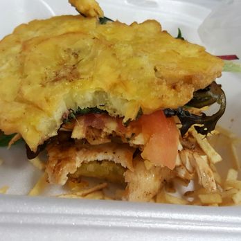 Atlantis Cafe - Chicken breast sandwich in between two tostones! - Coffee & Tea Near Me - Miami, Florida