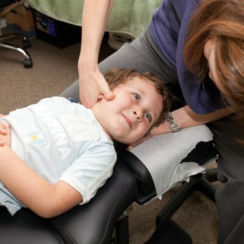 Center for Chiropractic + Wellness - Dr. Megan treating a young patient. - Chiropractors Near Me - Portland, Oregon