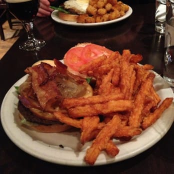 Prime 16 - The Smoker with sweet potato fries (front burger) The Cowboy with tater tots (back burger). - Burgers Near Me - New Haven, Connecticut Prime 16 - The Smoker with sweet potato fries (front burger) The Cowboy with tater tots (back burger). - Burgers Near Me - New Haven, Connecticut