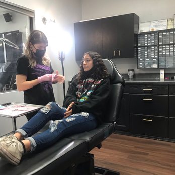 Windflower Piercing Studio - The piercer Jacqueline putting on gloves before she pierced my snake bites - Piercing Near Me - Fontana, California Windflower Piercing Studio - The piercer Jacqueline putting on gloves before she pierced my snake bites - Piercing Near Me - Fontana, California