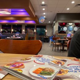 a table with a menu and a magazine on it
