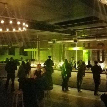 Anthology - a group of people standing in the rain - Music Venues Near Me - Rochester, New York
