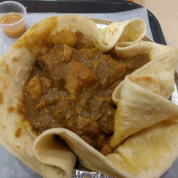 Kassim’s Bakery & Restaurant - Up close and personal with my chicken curry with a cup of hot sauce - Bakeries Near Me - Queens, New York Kassim’s Bakery & Restaurant - Up close and personal with my chicken curry with a cup of hot sauce - Bakeries Near Me - Queens, New York