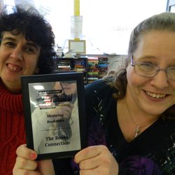 The Books Connection - Charlotte and Misty show off one of our 2 Vote 4 the Best Click on Detroit's Best Bookstore awards!