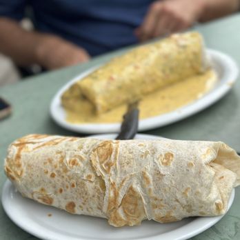 Wahoo's Fish Taco - Hawaiian Onion Rong Burrito in the foreground & Outer Reef Burrito smothered - Mexican Near Me - Denver, Colorado