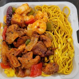 a take out container of shrimp and noodles a take out container of shrimp and noodles