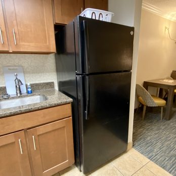 Coral Beach Resort - Kitchen with stove , microwave , coffee maker , full size refrigerator , plates , glasses , and utensils - Hotels Near Me - Myrtle Beach, South Carolina