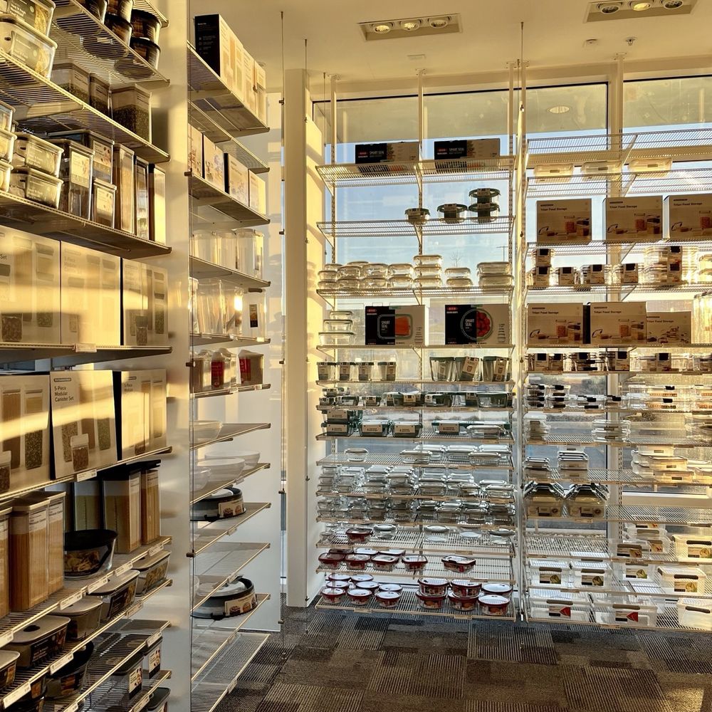 The Container Store - Clear and translucent containers line the glass shelves and curtain wall on a sunny winter day with corporeal light during the golden hour. - Home Decor Near Me - Peabody, Massachusetts The Container Store - Clear and translucent containers line the glass shelves and curtain wall on a sunny winter day with corporeal light during the golden hour. - Home Decor Near Me - Peabody, Massachusetts