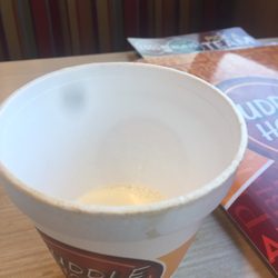 The cup of milk that they brought for my coffee.