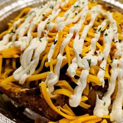 Full Potatoes - Plain jane is sautéed bacon topped with cheddar cheese and sour cream all laid inside of a baked potato $14 856.765.5940 or fullpotatoes.com