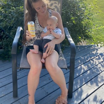 Saskatoon Brewery - a woman sitting in a chair holding a baby - Breweries Near Me - Saskatoon, Saskatchewan Saskatoon Brewery - a woman sitting in a chair holding a baby - Breweries Near Me - Saskatoon, Saskatchewan