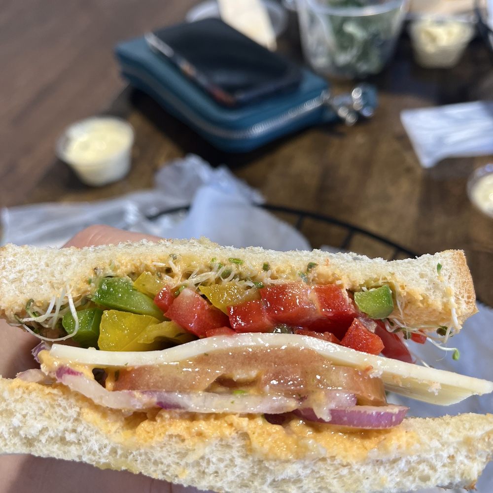 Haren’s Market - a person holding a sandwich - Grocery Near Me - Troy, Ohio