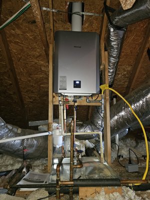 Tankless Water Heater Install - This installation was converted from a standard tank type water heater to a tankless water heater. We secured the new unit with 2x4's, installed a new vent through the roof with a new roof jack, installed new service valves and a neutralizer for the condensation drain. We can do the same for you. Call to schedule your FREE in home estimate.
