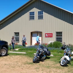 two motorcycles parked in front of a building two motorcycles parked in front of a building