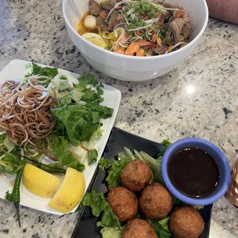 Bun Cha Ca Da Nang - Mi Quang Tom Thit (bowl and salad looking plate) Cha Ca Trung Cut (round looking food) - Vietnamese Near Me - Houston, Texas Bun Cha Ca Da Nang - Mi Quang Tom Thit (bowl and salad looking plate) Cha Ca Trung Cut (round looking food) - Vietnamese Near Me - Houston, Texas