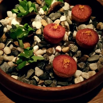 Commis - Caramelized onion financier with bee pollen, buckwheat oyster cracker with lovage and herbs. - New American Near Me - Oakland, California