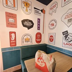 Jollibee - Achievements along the wall inside.