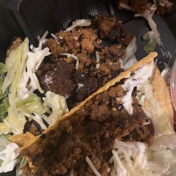 Bubbakoo's Burritos - TACO TRIO - Two tacos with seasoned ground beef, shredded lettuce, and cheese are placed on a bed of shredded lettuce and cheese, served on a black tray. - Mexican Near Me - Mount Olive, New Jersey