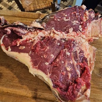 Braciere Malatesta - Raw Steak Florentine presented for approval before cooking. - Pizza Near Me - Florence, FI