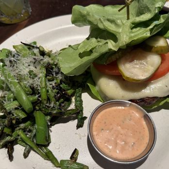 The Henry - All-American Burger* with lettuce bun and side of Grilled Asparagus & Snap Pea - New American Near Me - Phoenix, Arizona