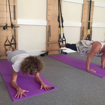 Sante Pilates Studio - Planking with feet in TRX straps - Pilates Near Me - Carpinteria, California