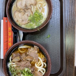two bowls of food on a tray two bowls of food on a tray