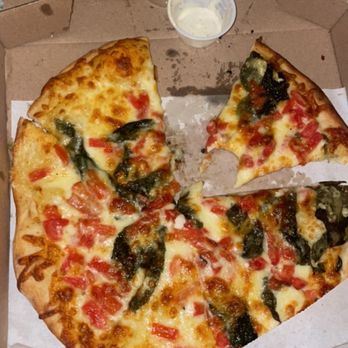 Bona Pizza - a pizza in a box with a slice taken out of it - Pizza Near Me - Dallas, Texas