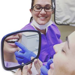 Nob Hill Dental Center - Dr. Kramer showing her beautiful Veneer to her patient!