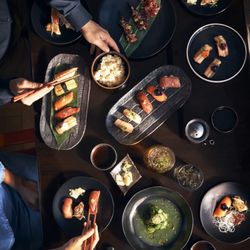 ONYX - A table plated with our signature sushi entrees.