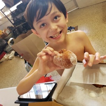 Leonard's Bakery - My nephew enjoying the filled puffs on his birthday. - Bakeries Near Me - Honolulu, Hawaii Leonard's Bakery - My nephew enjoying the filled puffs on his birthday. - Bakeries Near Me - Honolulu, Hawaii