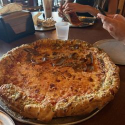 Ramunto's Brick & Brew Pizzeria - Famous garlic knot crust pizza (half sausage)