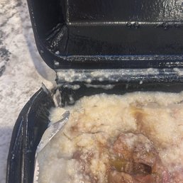Torn container where the Oxtail and Grits were carelessly prepared. Torn container where the Oxtail and Grits were carelessly prepared.
