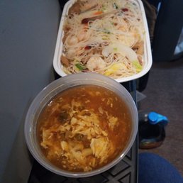 a bowl of soup and a container of noodles a bowl of soup and a container of noodles