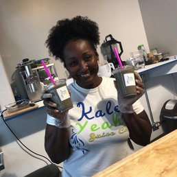 a woman holding a can of juice