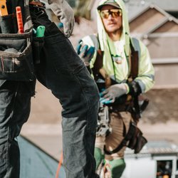 Moss Boss Roofing - Roofing professionals reviewing materials and installation details during a residential roofing project.