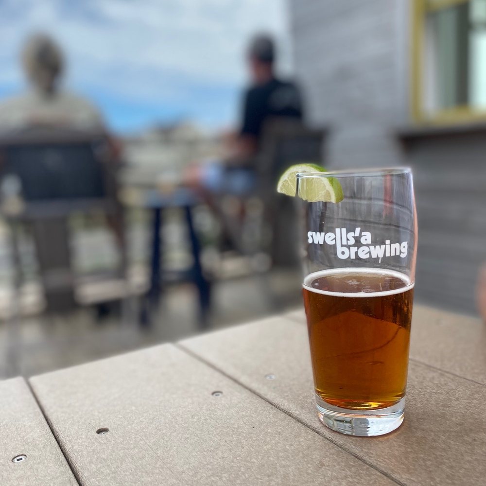 Swells’a Brewing - a glass of beer on a table - Breweries Near Me - Kill Devil Hills, North Carolina