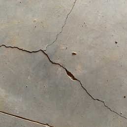 Cement Slab full of chips and cracks. Interior of home