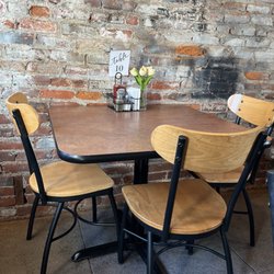 Mi Rincón - Cute cozy intimate dining. 4 main tables, a 2 top, & 3 bar stools at a spot looking out to patio.
